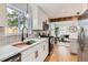 Bright kitchen features stainless steel appliances, quartz countertops and undermount sink overlooking the backyard at 1120 Xenia St, Denver, CO 80220