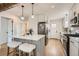 Modern kitchen featuring white cabinets, stainless steel appliances, and a stylish island at 1120 Xenia St, Denver, CO 80220