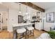 Bright kitchen with white cabinets, stainless steel appliances, and an open layout at 1120 Xenia St, Denver, CO 80220