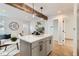 Bright open living area with wooden beams, modern light fixtures and access to the kitchen at 1120 Xenia St, Denver, CO 80220