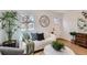 Cozy living room featuring a comfortable sofa, hardwood floors, and modern accents at 1120 Xenia St, Denver, CO 80220