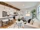 Open-concept living room and kitchen with hardwood floors and ample natural light at 1120 Xenia St, Denver, CO 80220