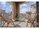 This balcony features two wood chairs overlooking the neighborhood at 9374 Loggia St # D, Highlands Ranch, CO 80126