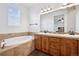 Bright bathroom with double vanity, soaking tub, and neutral colored walls at 9374 Loggia St # D, Highlands Ranch, CO 80126