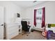 Bedroom featuring a bed, desk, and bay window with red curtains at 9374 Loggia St # D, Highlands Ranch, CO 80126