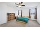 This bedroom is spacious and bright with a ceiling fan, two large windows, and a large shelving unit at 9374 Loggia St # D, Highlands Ranch, CO 80126