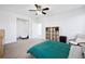 This spacious and bright bedroom is shown with attached seating area and large closet at 9374 Loggia St # D, Highlands Ranch, CO 80126