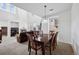 Dining room featuring a large wooden table and view into the living room at 9374 Loggia St # D, Highlands Ranch, CO 80126