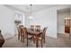 Formal dining room featuring a large wooden table and an overhead light fixture at 9374 Loggia St # D, Highlands Ranch, CO 80126