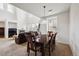 Open-concept dining area featuring a dark wood table with seating for six and views into the adjacent living room at 9374 Loggia St # D, Highlands Ranch, CO 80126