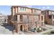 Beautiful exterior showcasing a blend of brick and stucco, a covered entry, and a well-maintained landscape at 9374 Loggia St # D, Highlands Ranch, CO 80126