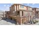 Lovely townhome displaying brick details, a private balcony, and an inviting entrance at 9374 Loggia St # D, Highlands Ranch, CO 80126