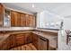 Kitchen with stainless dishwasher, granite counters, and wooden floors at 9374 Loggia St # D, Highlands Ranch, CO 80126