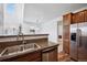 Kitchen featuring stainless appliances, granite counters, and adjacent dining area at 9374 Loggia St # D, Highlands Ranch, CO 80126