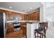 Open kitchen features stainless appliances, granite counters, and breakfast bar seating at 9374 Loggia St # D, Highlands Ranch, CO 80126