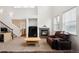 This living room features high ceilings, a cozy fireplace, and large windows for natural lighting at 9374 Loggia St # D, Highlands Ranch, CO 80126