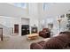 Cozy living room with a fireplace, a large window, and comfortable seating arrangement at 9374 Loggia St # D, Highlands Ranch, CO 80126