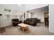 Inviting living room with high ceilings and large windows, complemented by comfortable seating and a view into the dining area at 9374 Loggia St # D, Highlands Ranch, CO 80126