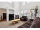 Spacious living room with high ceilings, a fireplace, and large windows offering plenty of natural light at 9374 Loggia St # D, Highlands Ranch, CO 80126