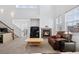 Inviting living room with a fireplace, comfortable seating, and a view of the staircase at 9374 Loggia St # D, Highlands Ranch, CO 80126
