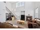 Bright living room features a fireplace, high ceilings, and staircase access at 9374 Loggia St # D, Highlands Ranch, CO 80126