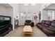 Bright living room with a fireplace, high ceilings, and large windows that provide natural light at 9374 Loggia St # D, Highlands Ranch, CO 80126