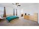 Spacious main bedroom features large dresser and ceiling fan at 9374 Loggia St # D, Highlands Ranch, CO 80126
