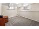 Unfurnished basement bedroom with carpet and small windows providing natural light at 1470 Utica St, Denver, CO 80204