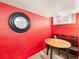Basement dining area with table and bench with a red wall at 1470 Utica St, Denver, CO 80204