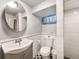 White-tiled bathroom with a modern vanity, a toilet, and a glass-enclosed shower at 1470 Utica St, Denver, CO 80204