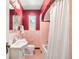 Vintage-style bathroom with pink tile, classic fixtures, and a shower-tub combination at 1470 Utica St, Denver, CO 80204