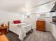 Basement bedroom with a bed, dresser, and small windows providing natural light at 1470 Utica St, Denver, CO 80204