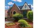 Charming brick Tudor-style home with a well-manicured front yard and unique architectural details at 1470 Utica St, Denver, CO 80204