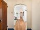 Elegant hallway with hardwood floors, arched doorway, and inviting natural light at 1470 Utica St, Denver, CO 80204