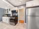 Modern kitchen with stainless steel appliances, white cabinetry, and ample counter space at 1470 Utica St, Denver, CO 80204