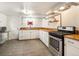 Basement kitchen with stainless steel appliances, butcher block countertops and white cabinets at 1470 Utica St, Denver, CO 80204