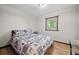 Bedroom features wood trim, light-colored walls and forest themed bedspread at 375 Castlewood Dr, Evergreen, CO 80439