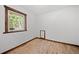 Empty bedroom with hardwood floors and wood trim around window at 375 Castlewood Dr, Evergreen, CO 80439