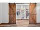 Closet with sliding wooden doors, mirror and shelving at 375 Castlewood Dr, Evergreen, CO 80439