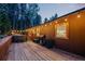 A spacious deck featuring a hot tub, grill, and string lights for outdoor enjoyment at 375 Castlewood Dr, Evergreen, CO 80439
