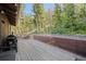 This large wooden deck has string lights and plenty of space for outdoor entertaining at 375 Castlewood Dr, Evergreen, CO 80439