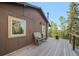 A rocking chair sits outside the back door of this cozy home with a view at 375 Castlewood Dr, Evergreen, CO 80439