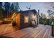 A cozy home featuring a wooden deck, a hot tub, and string lights for a relaxing ambiance at 375 Castlewood Dr, Evergreen, CO 80439