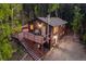 Rustic cabin with a spacious deck nestled in a serene forest setting, perfect for outdoor living at 375 Castlewood Dr, Evergreen, CO 80439