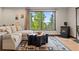 Inviting living room with a cozy fireplace, scenic views from large windows, and comfortable furnishings at 375 Castlewood Dr, Evergreen, CO 80439
