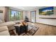 Cozy living room with a fireplace, large windows offering scenic views, and comfortable seating at 375 Castlewood Dr, Evergreen, CO 80439