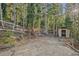 The lot contains an outdoor shed and room to park vehicles at 375 Castlewood Dr, Evergreen, CO 80439