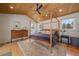 This lovely bedroom features a vaulted ceiling, a bed with wood frame and bright windows at 3800 Lakota Rd, Indian Hills, CO 80454