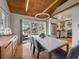 Bright dining area offers a view to the exterior, modern light fixture and access to the kitchen at 3800 Lakota Rd, Indian Hills, CO 80454