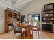 Open dining area features a wooden table, a hutch, and natural light from sliding glass doors to the patio at 3800 Lakota Rd, Indian Hills, CO 80454